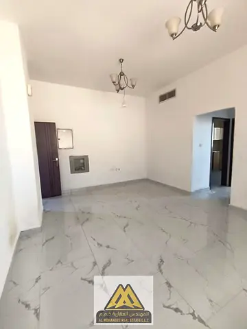 One-bedroom apartment with a living room for annual rent in Al Alia, Ajman, featuring a balcony, ce