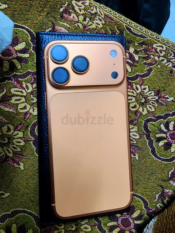 iPhone with protective gold case — good condition, working
