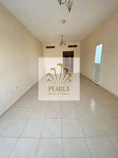 Luxury apartment for annual rent in Orient Towers, Ajman. Two bedrooms and a living room with a mast