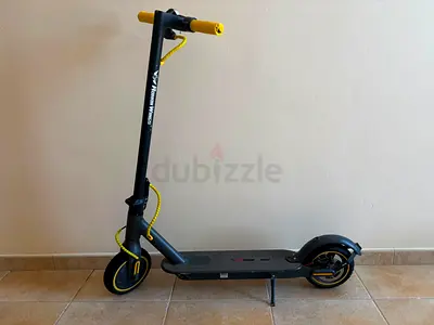 Foldable electric kick scooter with yellow grips - good condition