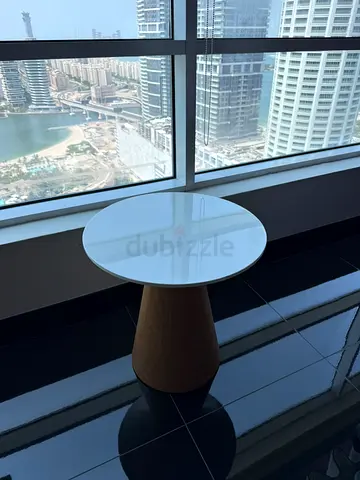 Small round side table with white top and wooden base