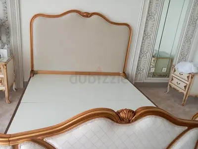 Branded King-sized ornate upholstered bed frame with gold trim with mattress only
