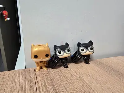 Rare golden batman funko + 2 catwoman