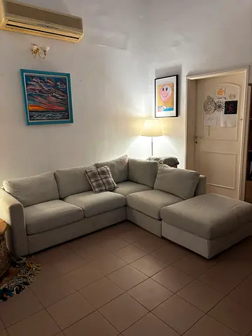 Light grey Ikea modular L-shaped corner sofa with chaise and storage — good condition AED550