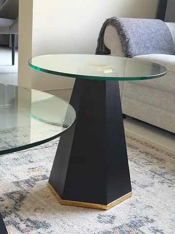 glass-top black coffee table with two side tables