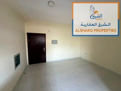 Studio apartment with separate kitchen, central air conditioning, spacious layout, prime location, and easy access to Dubai and Sharjah.