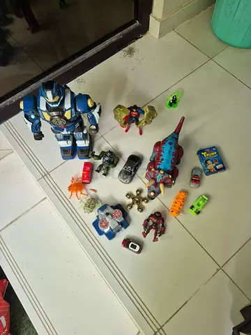 Collection of Action Figures, Toy Cars, and Dinosaur