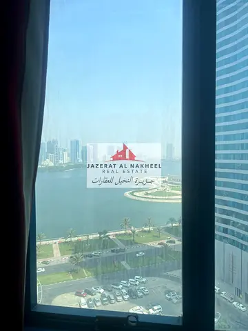 For sale: Three bedrooms and a living room in Al Majaz 3 with two parking spaces, boasting a stunni