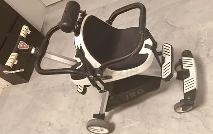 Compact convertible push ride-on stroller with safety bar and footrest