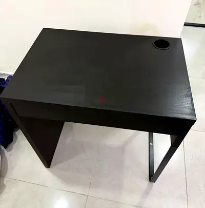 Compact dark wood computer desk with cable grommet