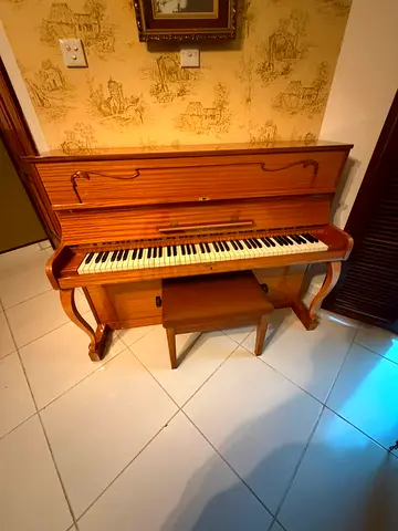 Upright Piano in good working condition with bench