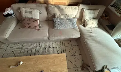 Light beige L-shaped fabric sofa with chaise, good condition with cushions if buyer would like them