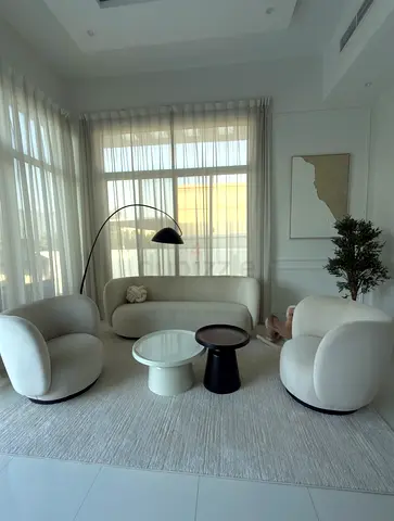 Modern cream living room set — sofa, two swivel chairs and coffee tables