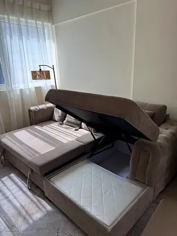Light brown fabric sofa with storage and pull-out bed, good condition