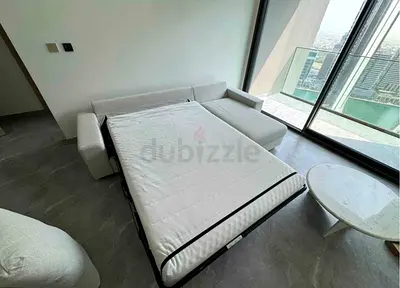 Light L-shaped sofa bed with pull-out mattress – good condition