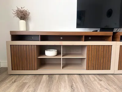 Wall-mounted entertainment unit with storage shelves and cabinets