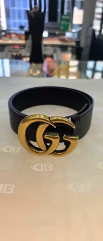 Black leather belt with gold double-G buckle