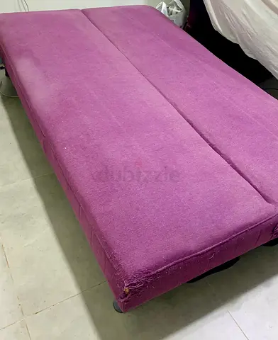 Purple fabric sofa bed / futon in good used condition
