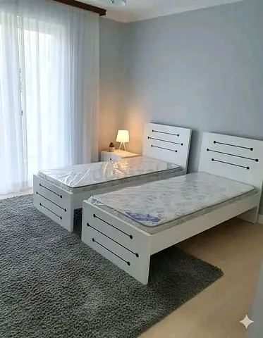 New Pair of white single beds with mattresses