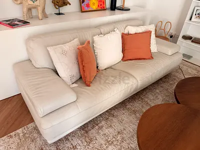 Two cream leather 3-seater Natuzzi sofa in good condition