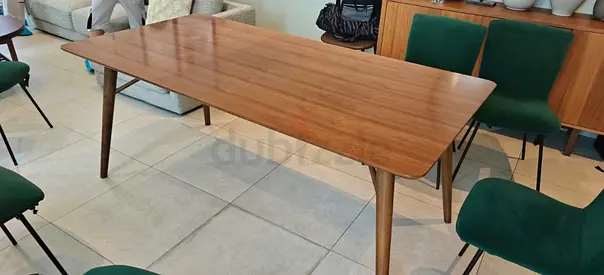 Wooden Table with Tapered Legs with few marks on Top.