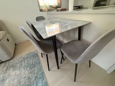 Marble-top dining table with 4 grey fabric chairs - compact set