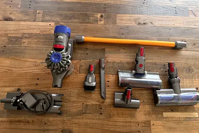 Dyson V8 cordless stick vacuum with multiple attachments - decent condition