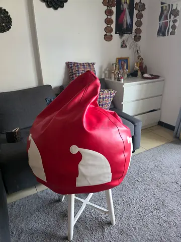 Red leather-like bean bag chair decorated with white Santa hat patterns. good condition
