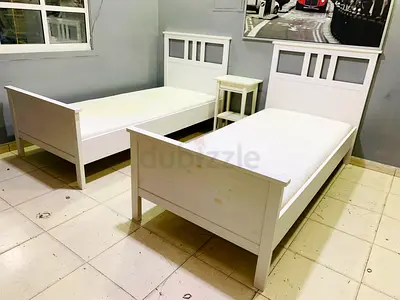 Pair of single white wooden beds with bedside table - good condition