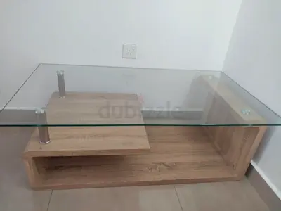 Modern glass-top coffee table with wooden shelf