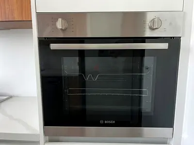 Bosch built-in gas oven. It features a modern stainless steel and black glass finish