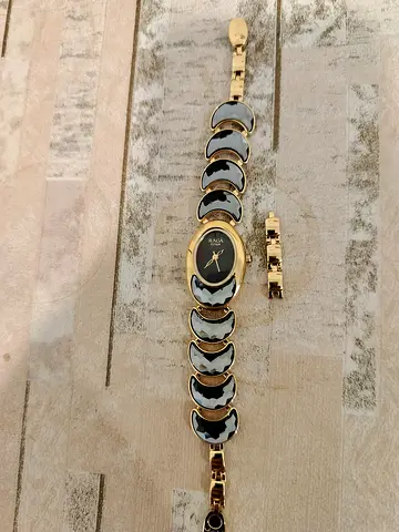 Raga cocktails by Titan women's gold-tone bracelet watch with actual links.