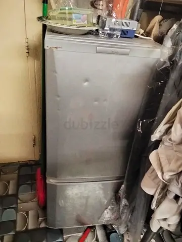Used small refrigerator/freezer - compact upright unit, some dents, works