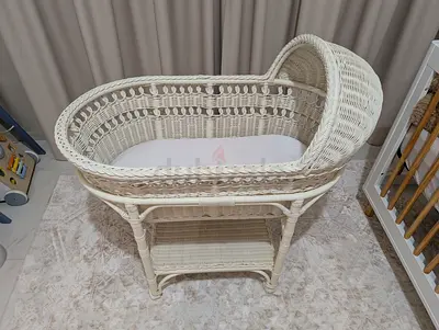 Pottery Barn Kids Vintage-style white wicker baby bassinet with mattress