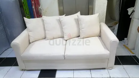 Beige 2-Seater Sofa bed with Cushions — Good Condition