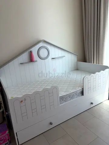 White wooden kids bed with pull out storage drawer