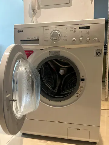 LG Front Load Washing Machine - 7 kg, Working Condition but need repair for leak.