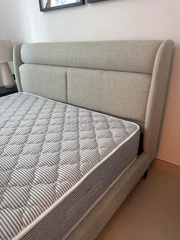 Light grey upholstered double bed frame without matras