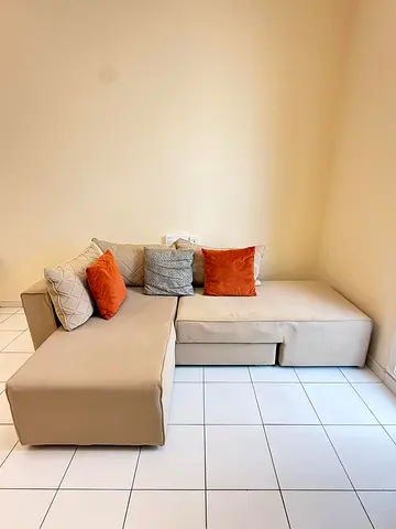 Beige L-shaped Sofa Bed from Danube Homes with Ottoman and Cushions - New Condition