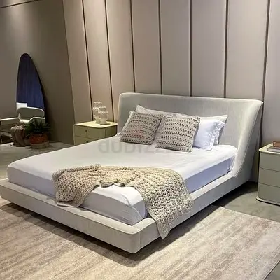 Low-profile upholstered double bed with padded headboard — light beige