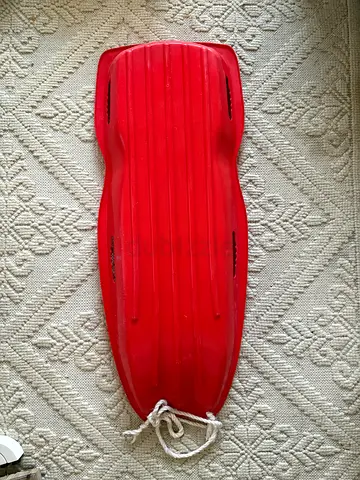 Red plastic snow and safari sled / toboggan with rope - good condition