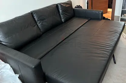 Black leather sofa bed - great condition, converts to bed