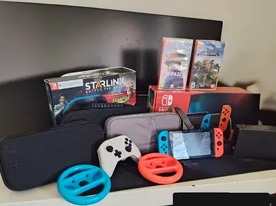 Nintendo Switch, 1 extra controller, 2 Racing grips, 4 games and full starlink battle of atlas set