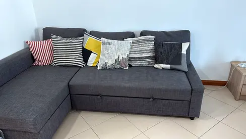 L-shaped grey fabric sofa with chaise and storage – good condition