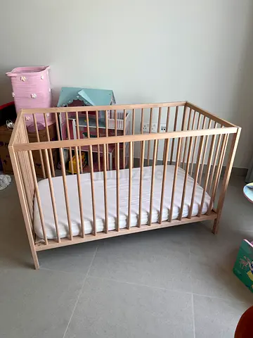 Solid wooden baby crib with mattress