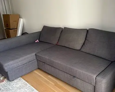 Grey L-shaped fabric sofa with storage - good condition
