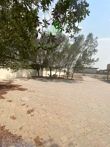 Yard for Annual Rent in Al Sajaa with 20,000 Sq Ft Space 32 KW Electricity Two Rooms Kitchen Bathroom and Asphalt Road