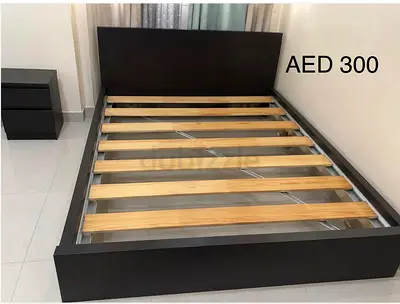 Queen wooden bed frame with headboard and slats - good condition, AED 300