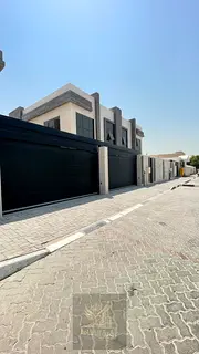 For rent in Al Jazzat, brand new two-story villa with 4 spacious master bedrooms, prime location, 4 