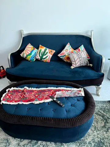 Blue velvet vintage-style sofa with matching ottoman. 7 seater, with 6 big matching cushions.